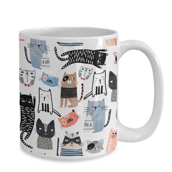 A coffee or tea mug with many colorful cats on Etsy