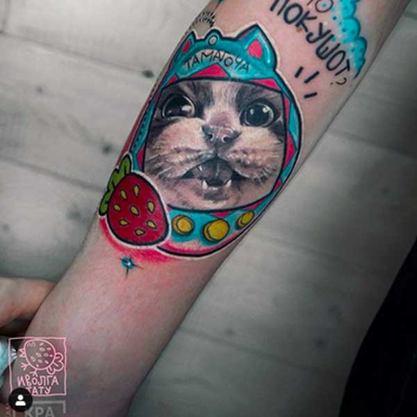 A cartoon cat tattoo by ivolgatattoo