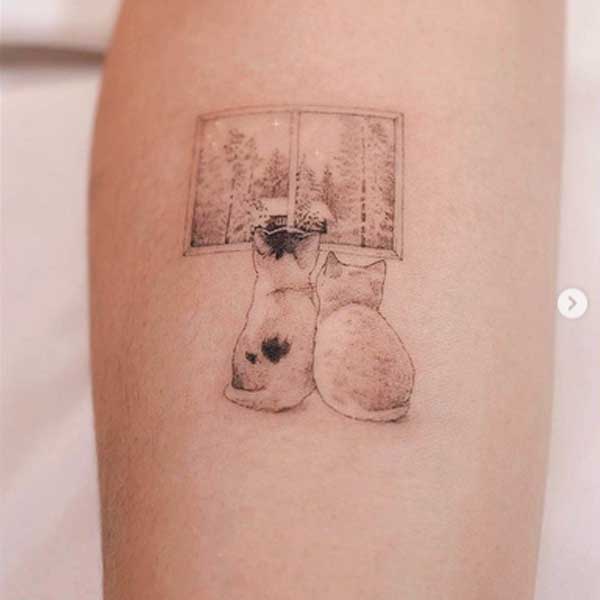A minimalist tattoo of two sitting cats by SOL