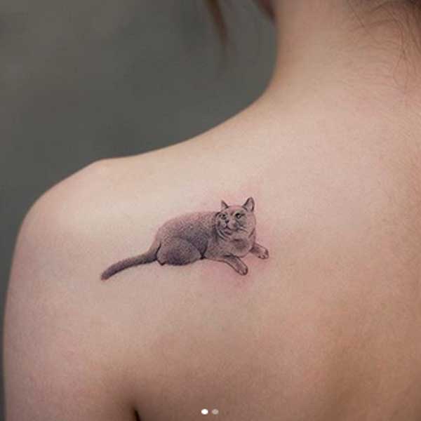 Black and white traditional tattoo of lying cat by AkiWong