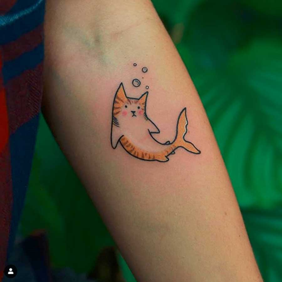 A cat outline tattoo by Matuszka Tattoo