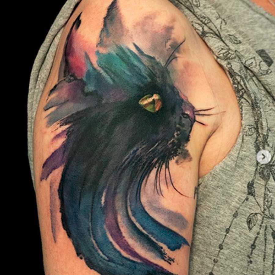 A watercolour black cat tattoo by artist alexalvaradotattoos