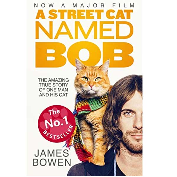 A young man with a cat named Bob on his shoulder