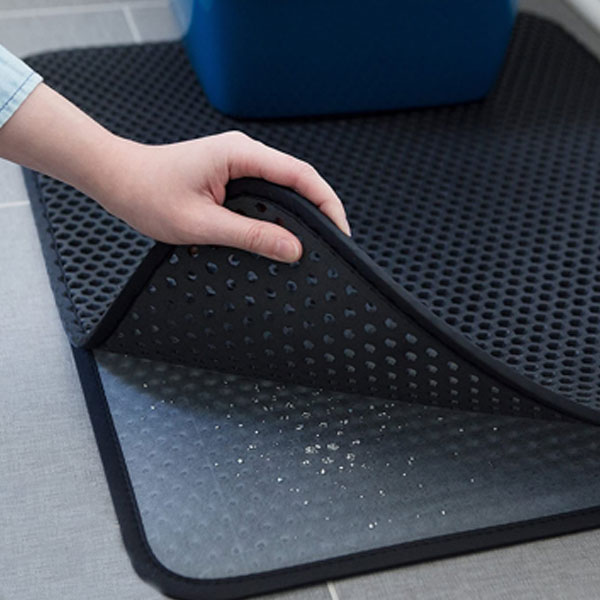 grey cat litter mat with honeycomb-shaped holes 
