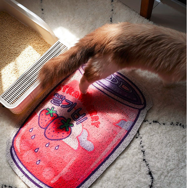 a cute cat litter mat in the pattern of straberry soda