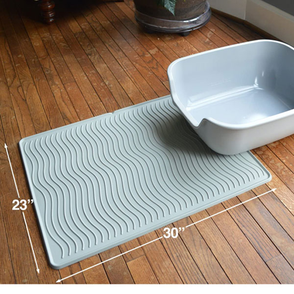 cat litter box and mat in pastel blue color on wooden floor 